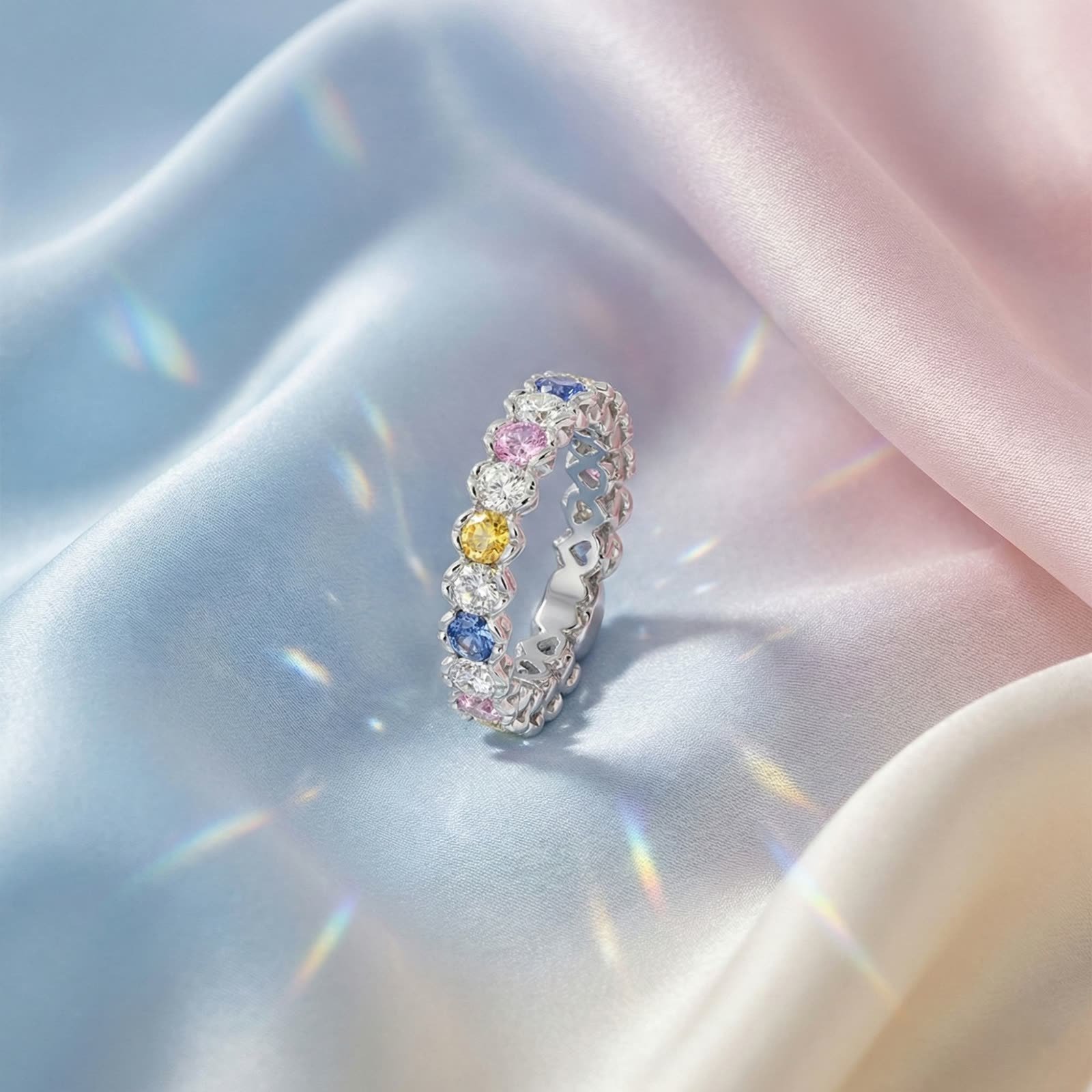 AI jewellery design: Multi-colour sapphire and diamond eternity ring on pastel satin